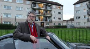 Douglas Skelton standing next to a black sports car