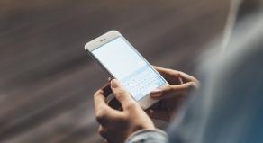 A woman typing a message on her smartphone