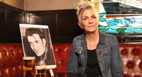 Denise Mina in a pub with a picture of Peter Manuel