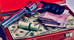 A leather suitacse full of dollars and a smith and western revolver