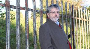 Douglas Skelton leaning against a fence