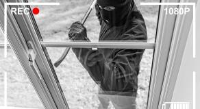 CCTV footage of a burglar breaking through a home window