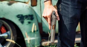 A man holds a handgun