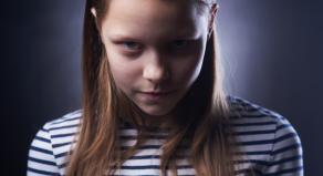 Portrait of a little girl with evil face
