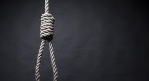 A photograph of gallows on a black background