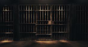 A stock photo of a dark prison cell