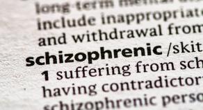 A close up photo of the word 'schizophrenic' in a dictionary.