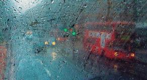 A photograph showing a view of London through the top window of a double-decker bus
