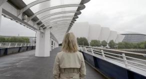 Emilia Fox facing away from camera in front of the Clyde Auditorium (SEC Armadillo)