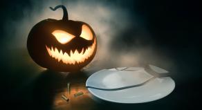 A stock photo of a pumpkin, three bullet cases and a broken plate