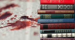 A stock image showing books and a blood stain on a book page