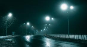 A stock photo showing street lights in the fog