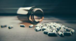 A stock image showing an open jar of pills