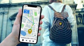 A stock image showing a mobile phone and a tracking device clipped onto a rucksack