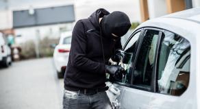 A man breaking into a car
