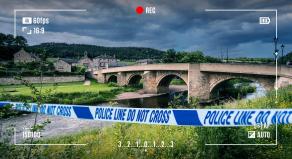 A CGI graphic showing police tape in front of a road bridge at Rothbury, Northumberland