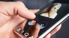 A man using a dating app on a smart phone