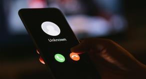 A smartphone showing a phone call from an unknown number