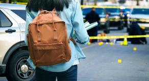 A stock image of a student looking at a crime scene