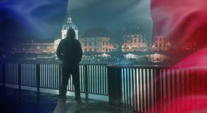 A hooded figure lurking on the banks of the Seine