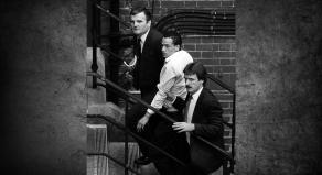 Kenneth Erskine being led up some stairs by two detectives