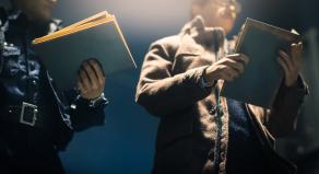 Two detectives looking at files