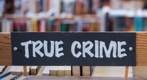A 'true crime' sign in a library