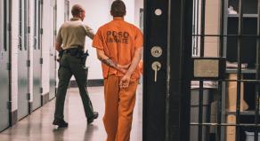 An inmate wearing an orange jumpsuit