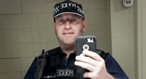 David Carrick wearing police uniform posing for a mirror selfie