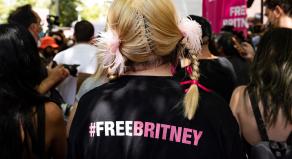 A woman wearing a t-shirt with #FREEBRITNEY written on the back