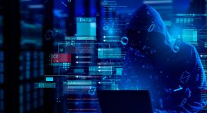 A hooded figure looks at a laptop surrounded by code and data warnings