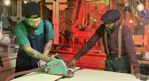 Taury Meade uses a buzz saw while his dad, Raphael, watches on