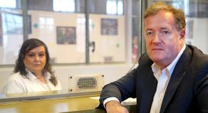 Piers Morgan posing with Kimberly Saenz on either side of a protective screen