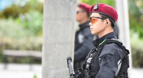 Armed police patrolling a park in Marina Bay