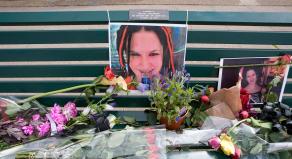 A park bench with photographs of Sophie Lancaster and flowers laid on top