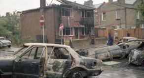 Burned out cars on the street the day after the Broadwater Farm Riots