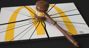 A judge's gavel smashes the McDonald's logo