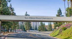 A bridge over a road that reads 'San Diego State University'