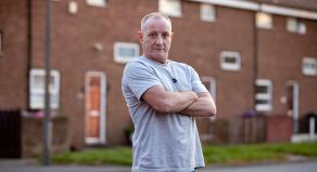 Paul Massey standing with his arms crossed