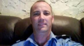 Adrian Trevor Moore takes a selfie while wearing his police uniform