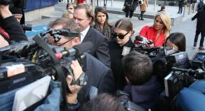 Belle Gibson is swarmed by cameras as she leaves court