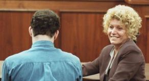 Leslie Abramson smiles in court while Erik Menendez sits with his back to the camera