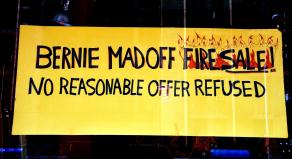 Sign in the window of a guitar shop that reads 'Bernie Madoff Firesale! No reasonable offer refused'