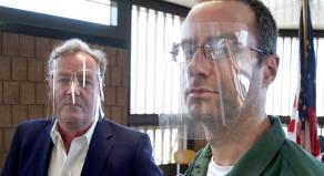 Piers Morgan standing with Christopher Porco - both are wearing clear plastic visors