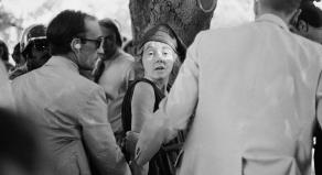 Lynette 'Squeaky' Fromme looks at a camera while being arrested for the attempted assassination of President Ford