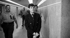 Tex Watson is led back to jail from the courthouse while wearing handcuffs