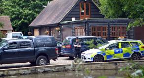 Police cars outside John Palmer's home in Essex following his murder