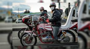 Two Bōsōzoku bikers driving old Japanese bikes in 2016. They are extravagantly decorated