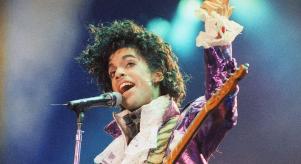 Prince wears a sparkly purple jacket as he performs in 1985