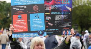 A woman holds up a sign outlining the dangers of fentanyl in Washington DC